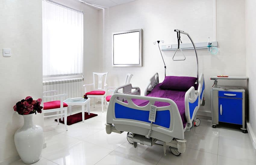 Icu Hospital Bed In A Room With Two Chairs
