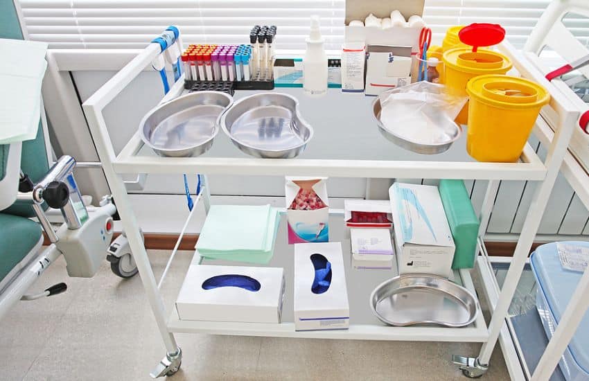 Mayo Stand With Surgical Supplies Laid On It.