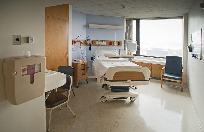 A Comfortable Hospital Room With A Used Hospital Bed.